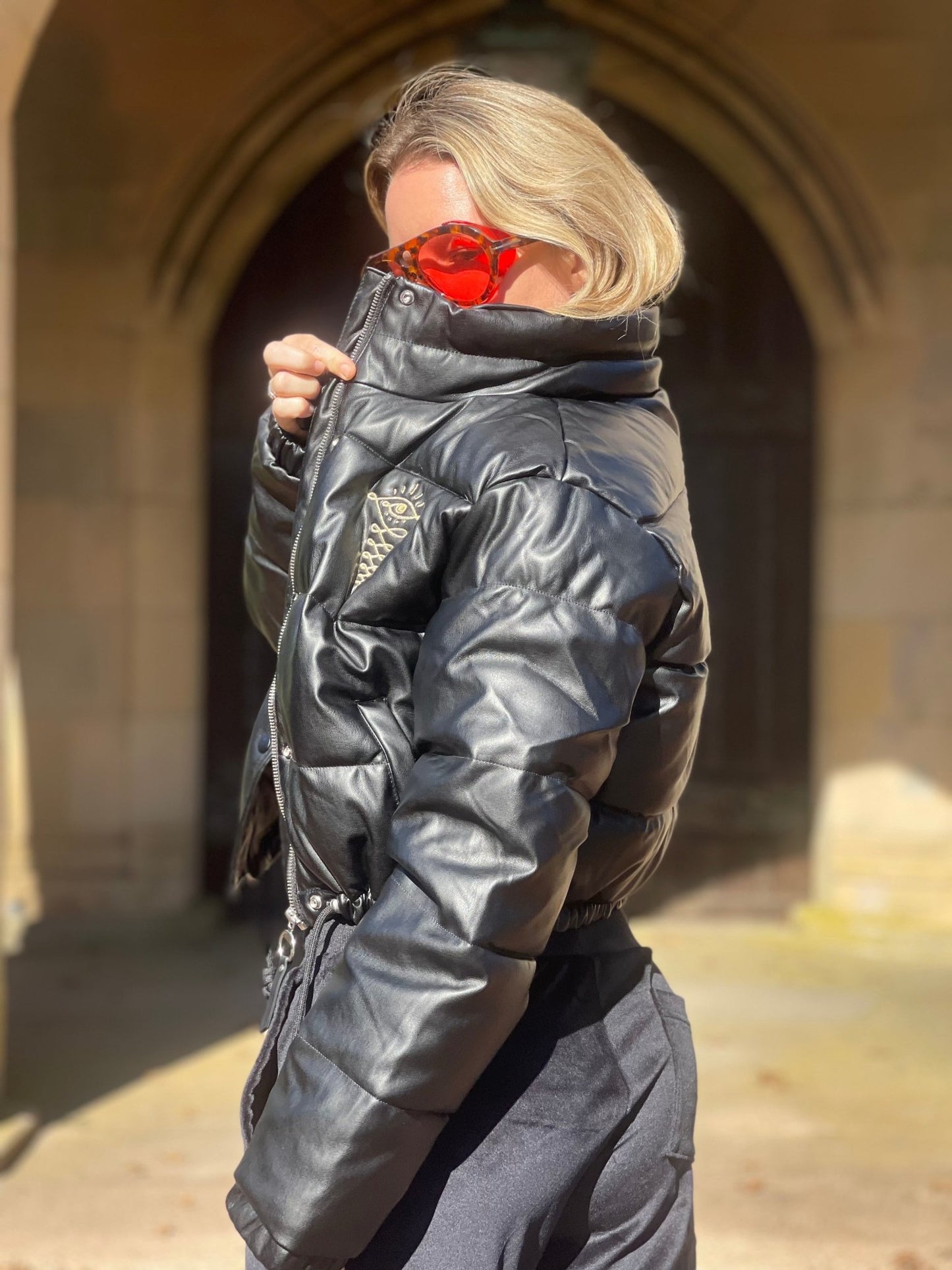 Embroidered Gold Eye Logo Shiny Faux Leather Puffer Jacket - Camaroha Sutra